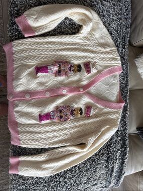 Cream Cable Knit Cardigan with Pink Trim & Sequin Nutcracker Motifs